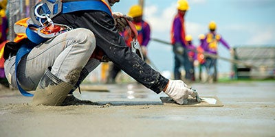 worker smoothing concrete