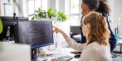 two people looking at computer