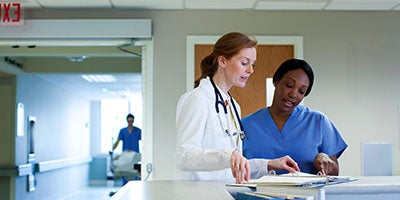 two healthcare workers talking