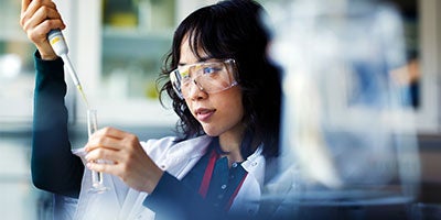 researcher pipetting liquids