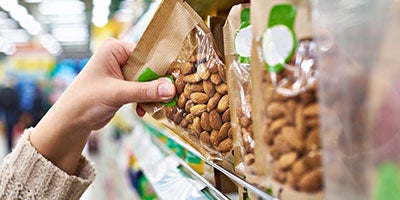 reaching for shelf of almonds