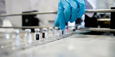 hand reaching for vials