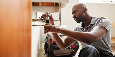 man fixing pipe