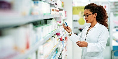 pharmacist browsing shelves