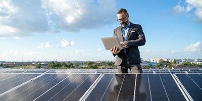 man behind solar panels