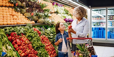 grandmother and granddaughter grocery shopping