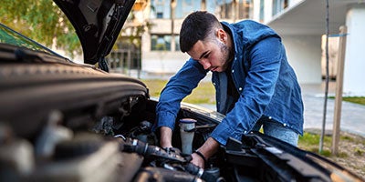 person fixing car