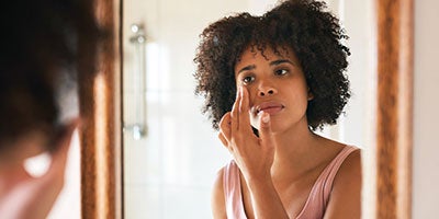 woman looking into mirror