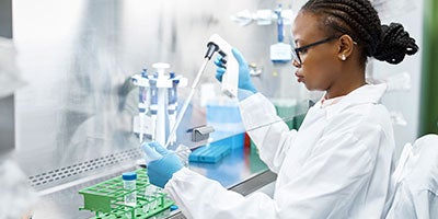 researcher using pipettes