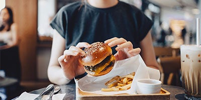 person holding burger