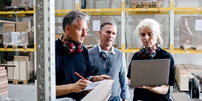 three people in warehouse