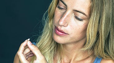 woman holding vitamin