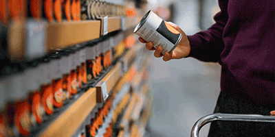 person shopping for canned foods