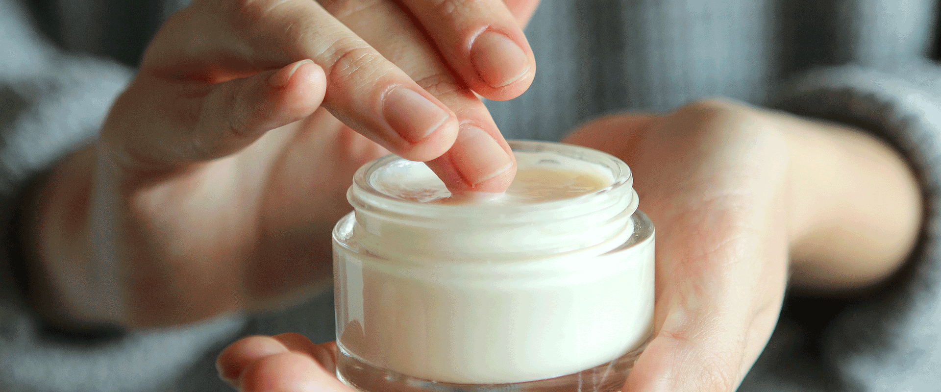 hand holding lotion container