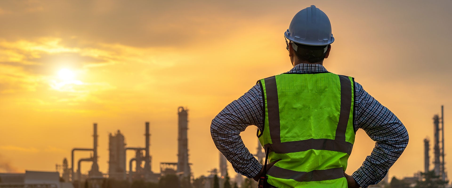 industrial worker looking into sunset