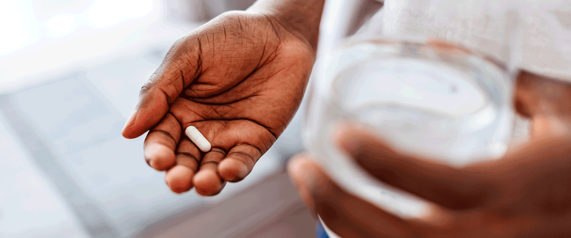 man holding vitamin in hand