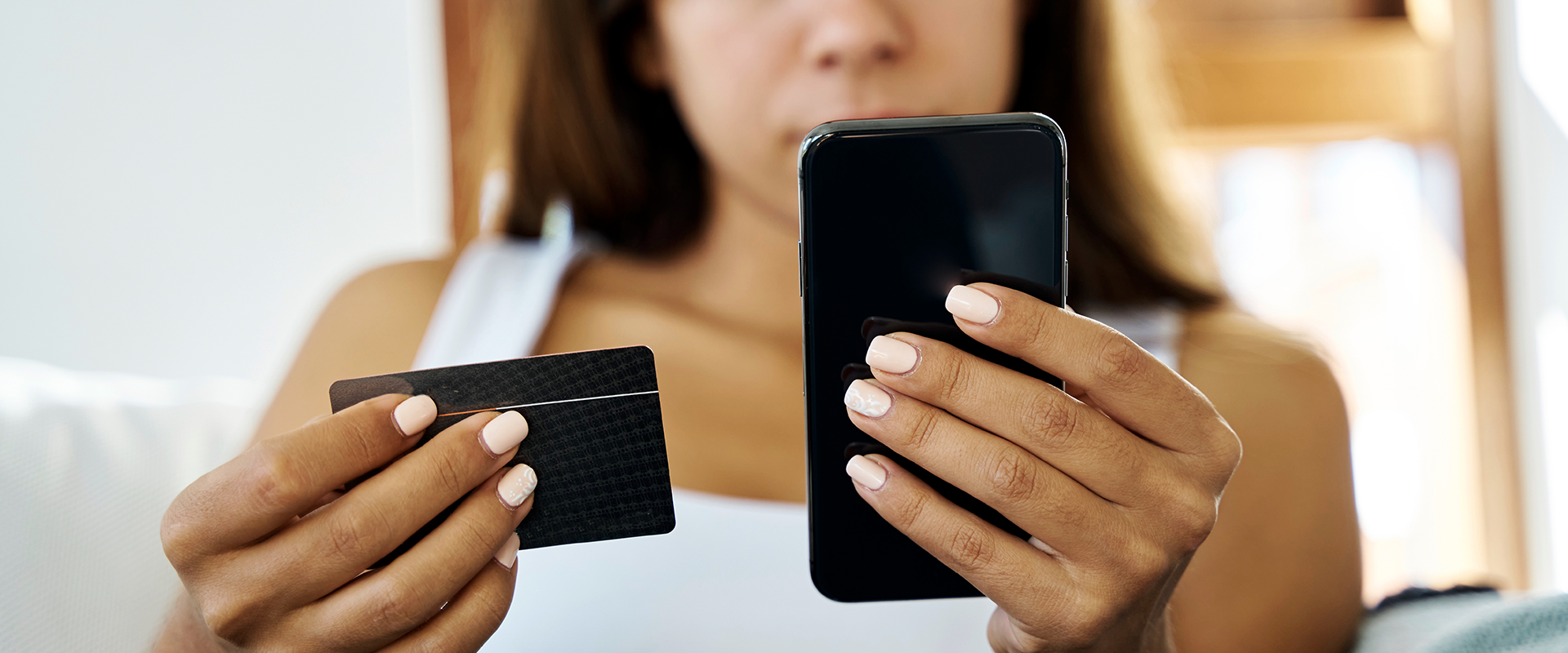 woman holding phone and credit card