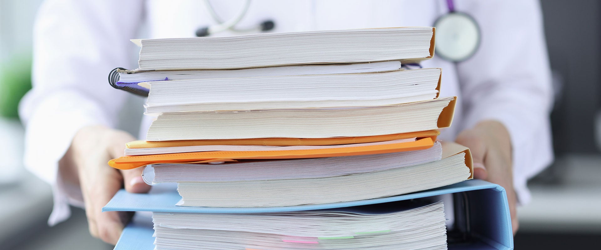 doctor with stack of books