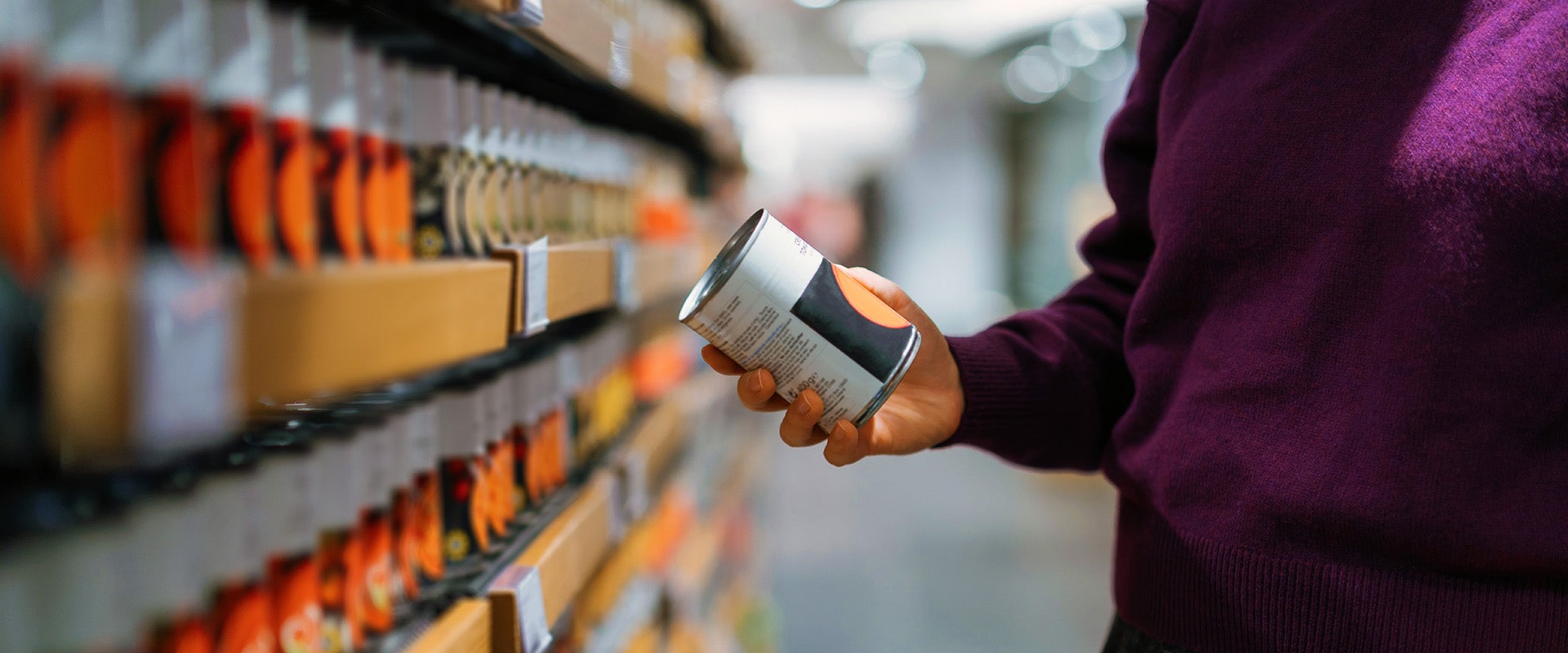 woman picking up soup can 