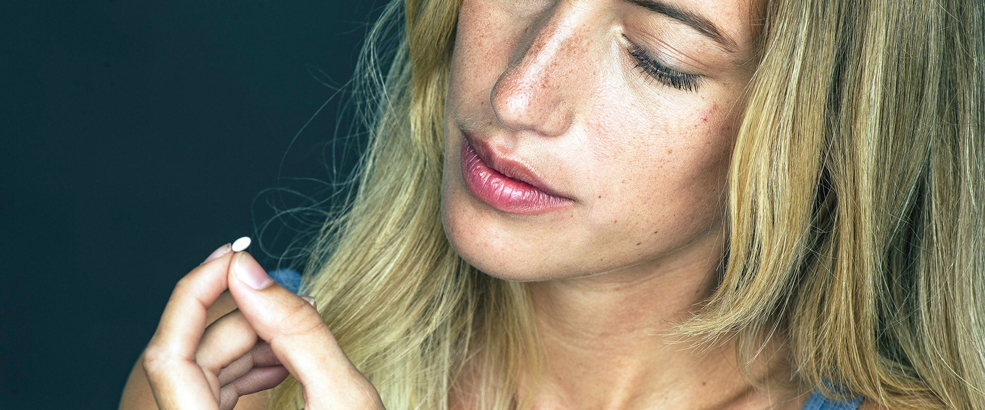 woman holding pill