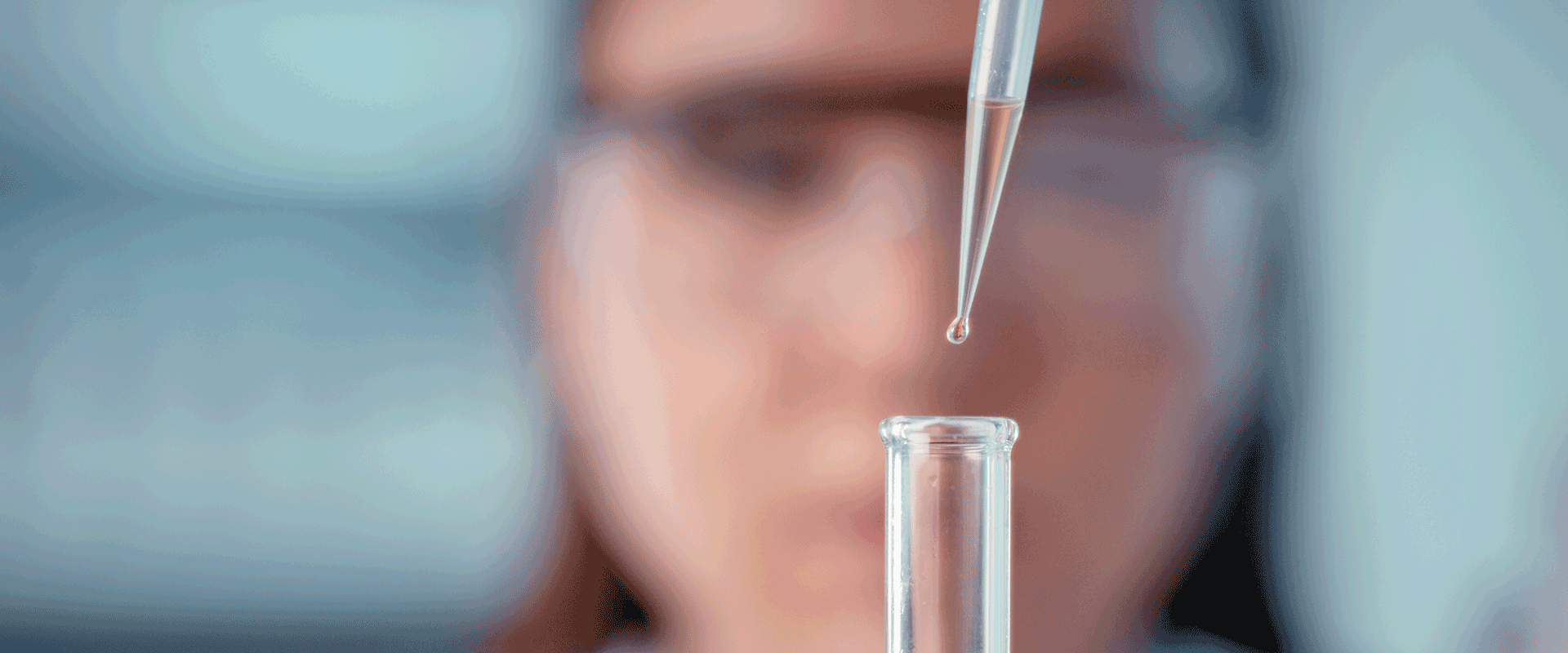 researcher pipetting liquid into vial 