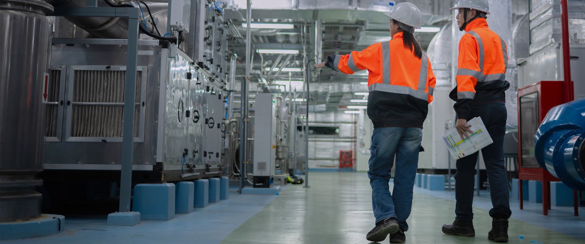 Two plant workers inspecting machinary