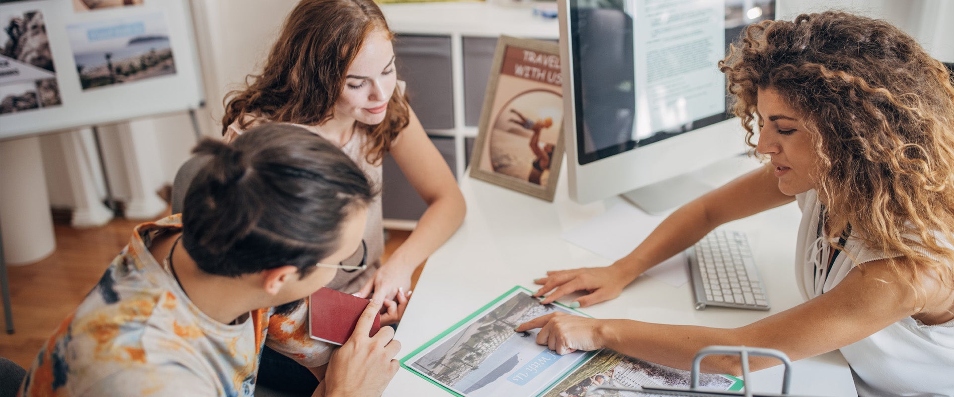 People discuss travel plans around a table