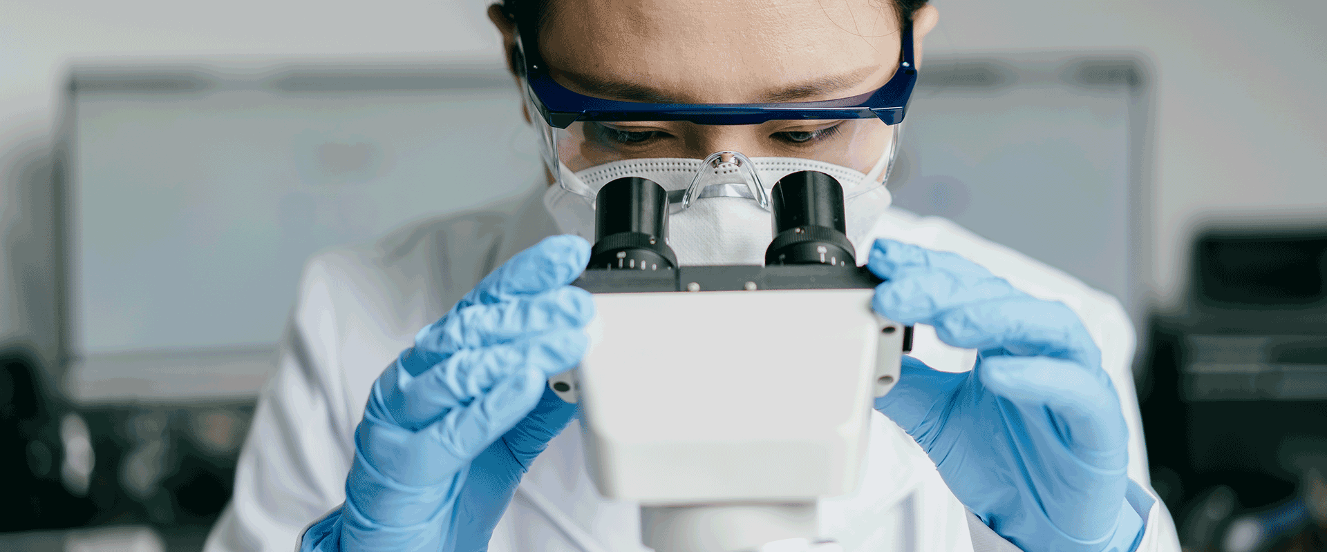 scientist viewing microscope