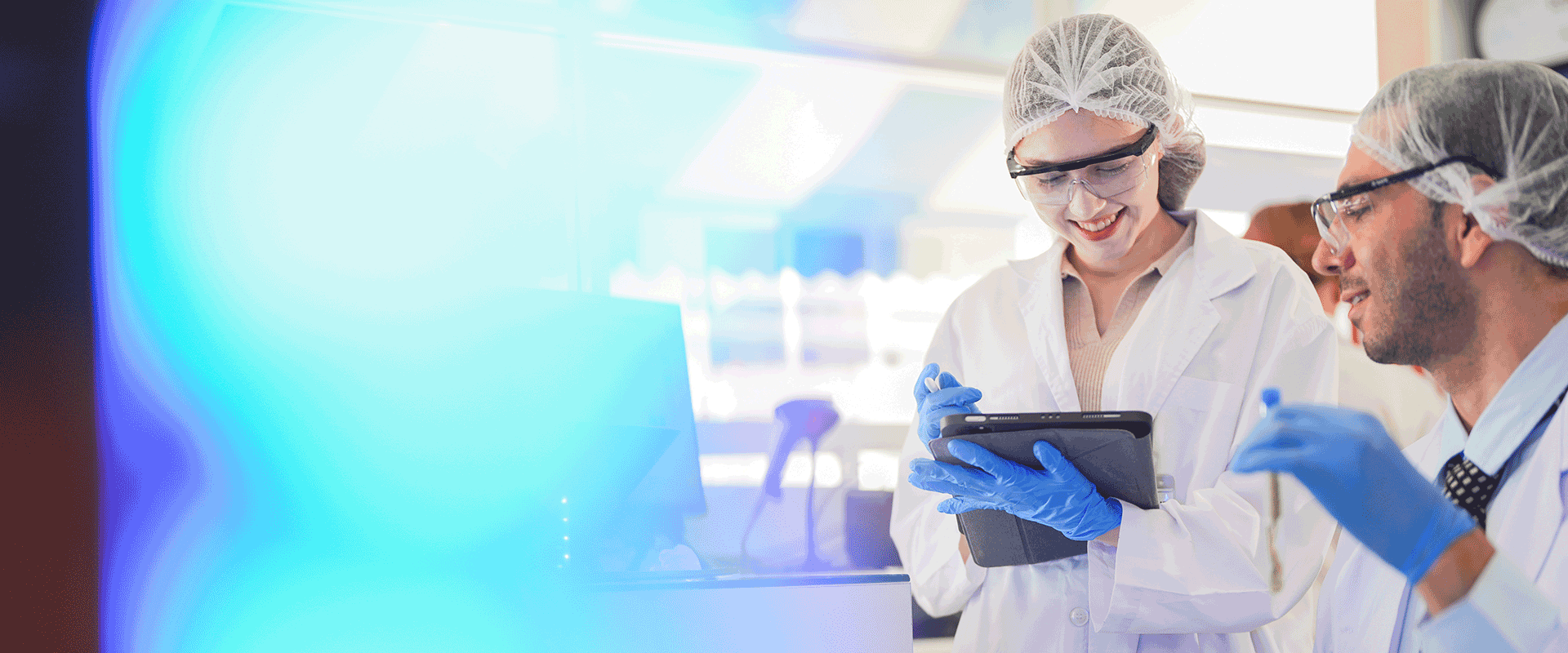 researchers in lab with blue light reflected 