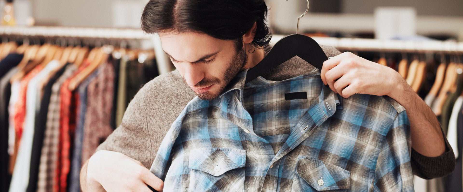 man trying on shirt