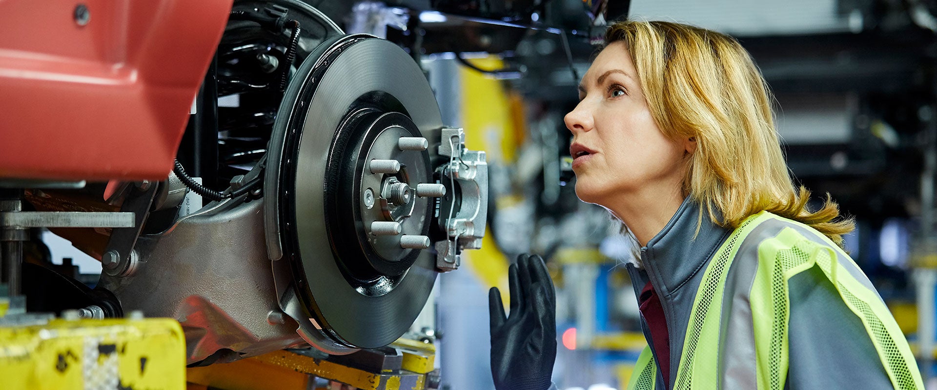 automotive engineer examining car