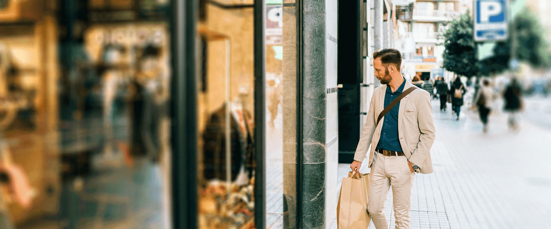 man walking past retail store