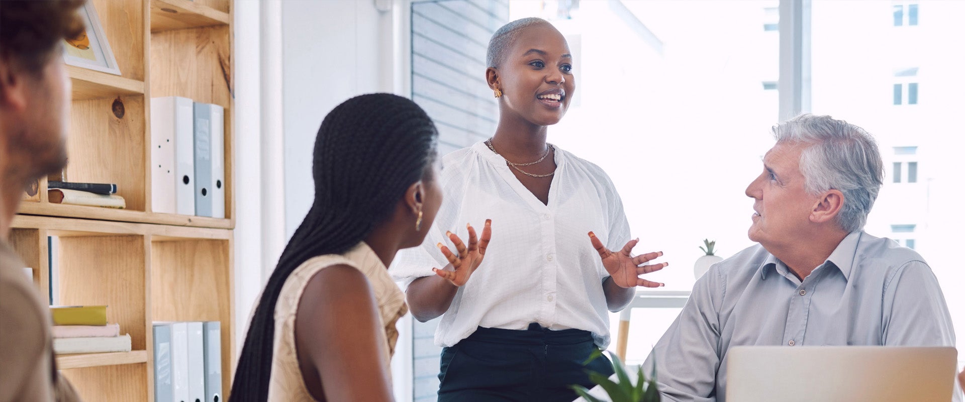 Woman discussing client work in team meeting