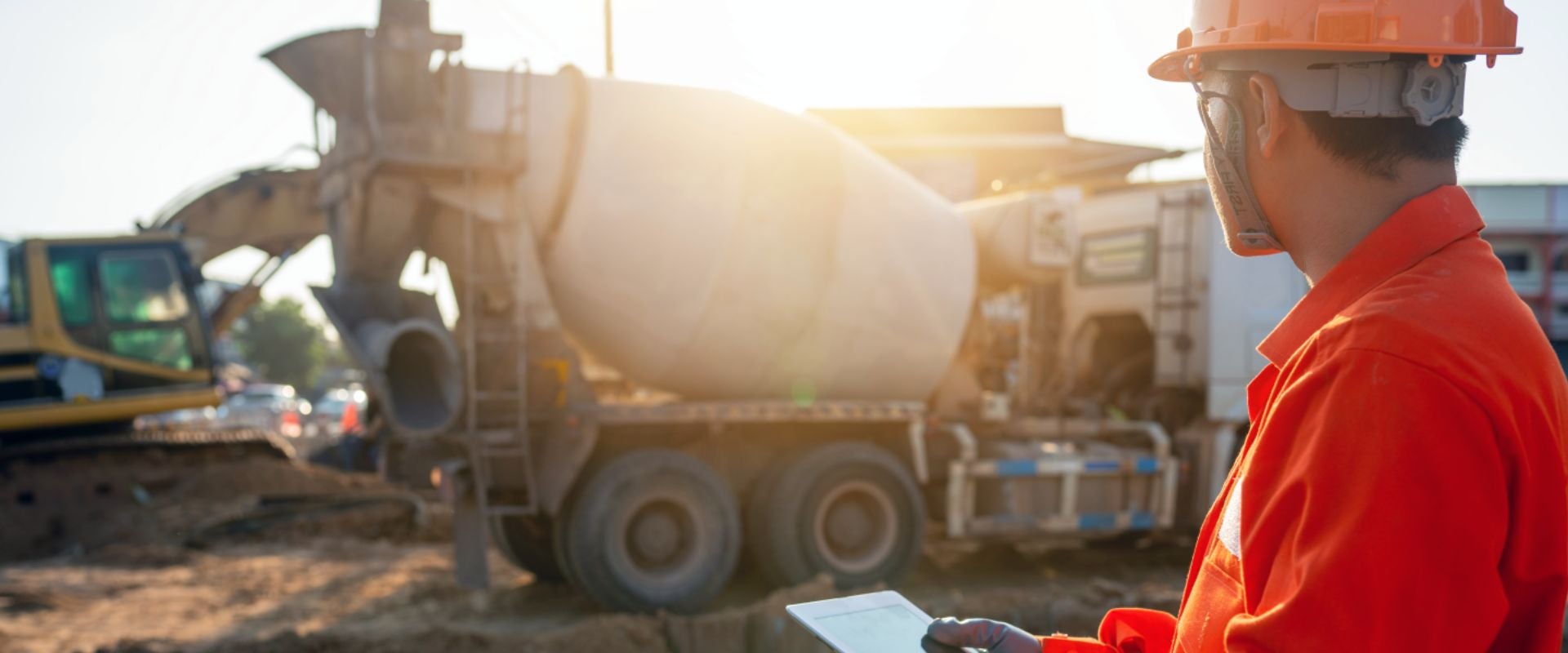 man looking at cement mixer