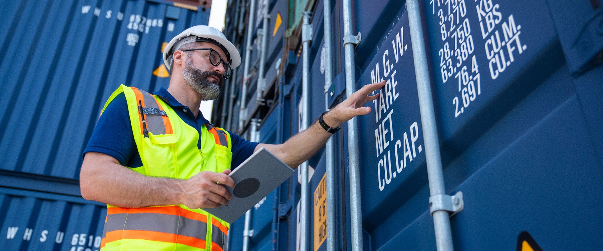 person pointing to shipping container