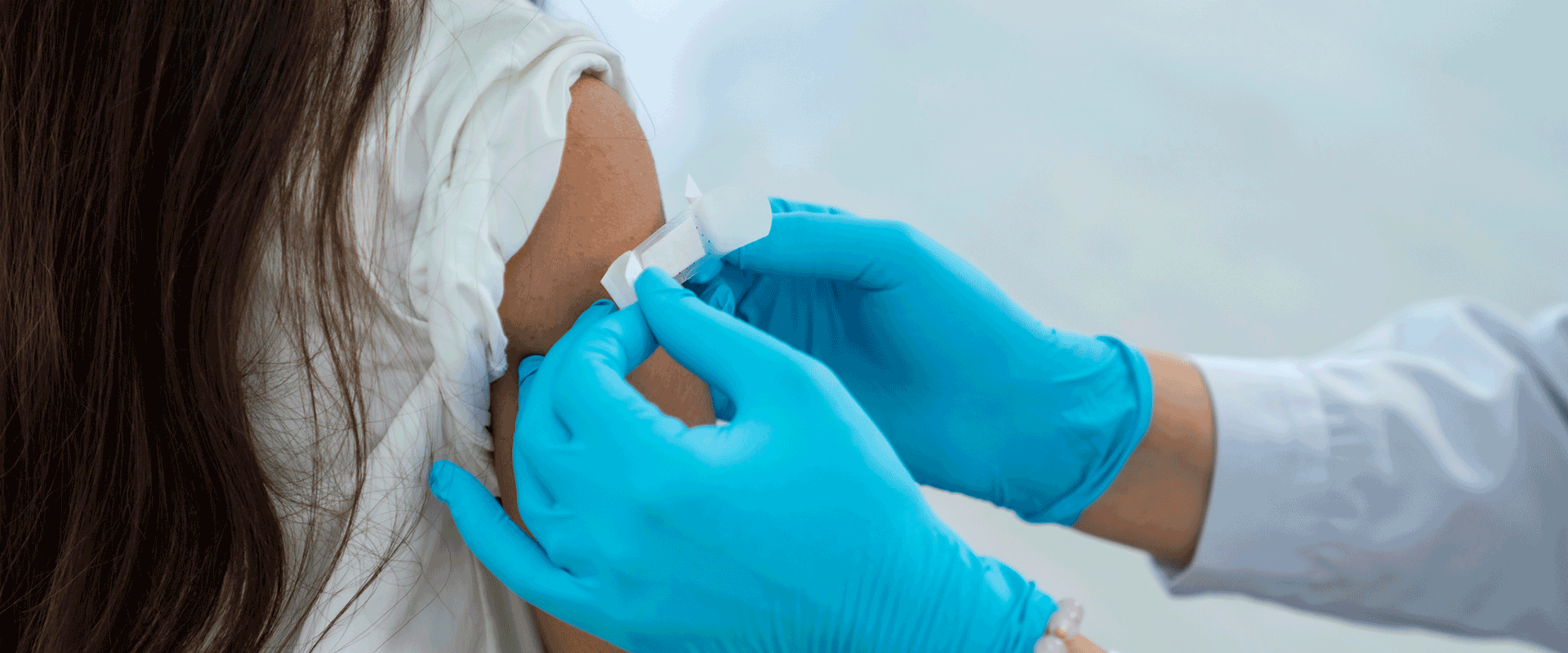 pharmacist administering vaccine in arm