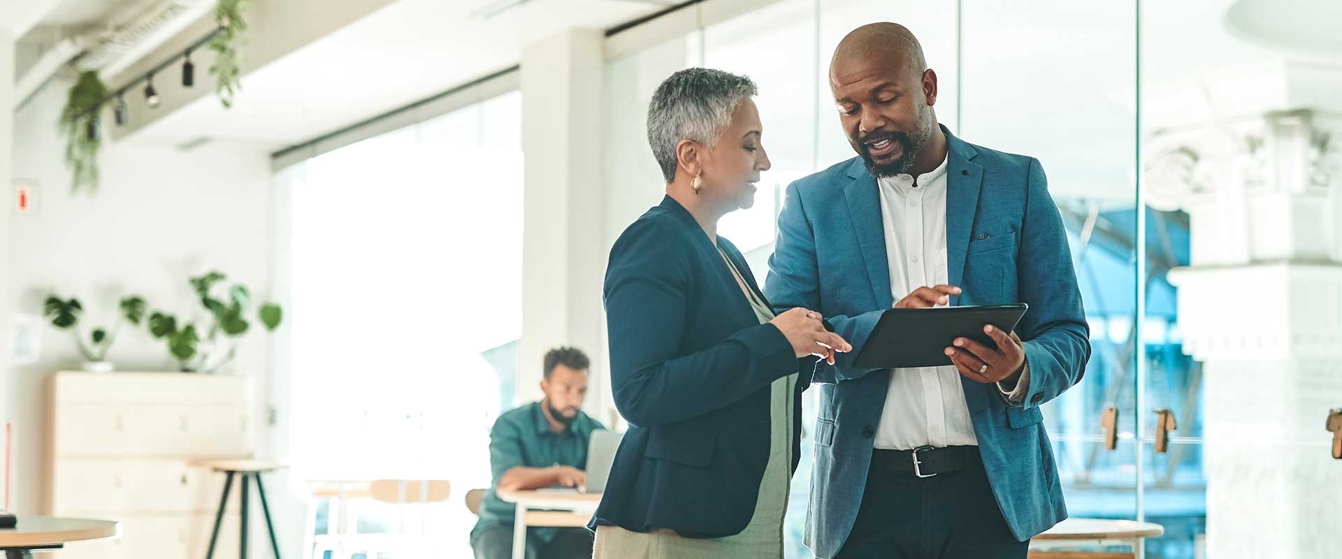 two colleagues chatting in office