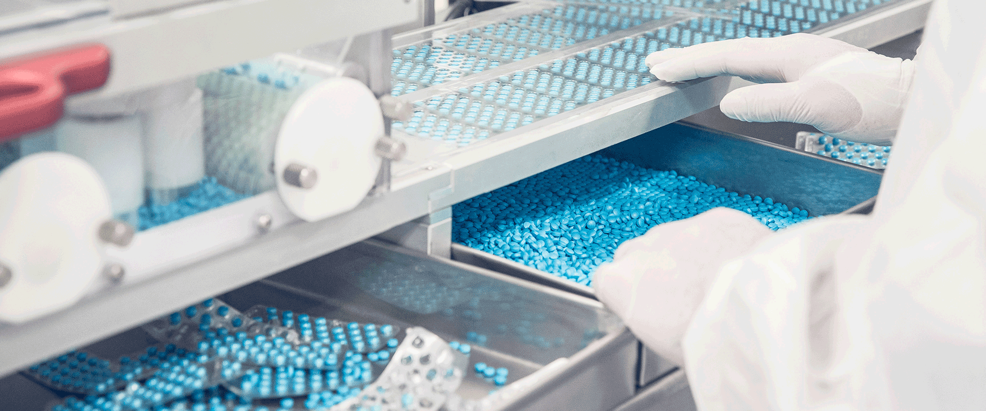 worker sorting pills during manufacturing