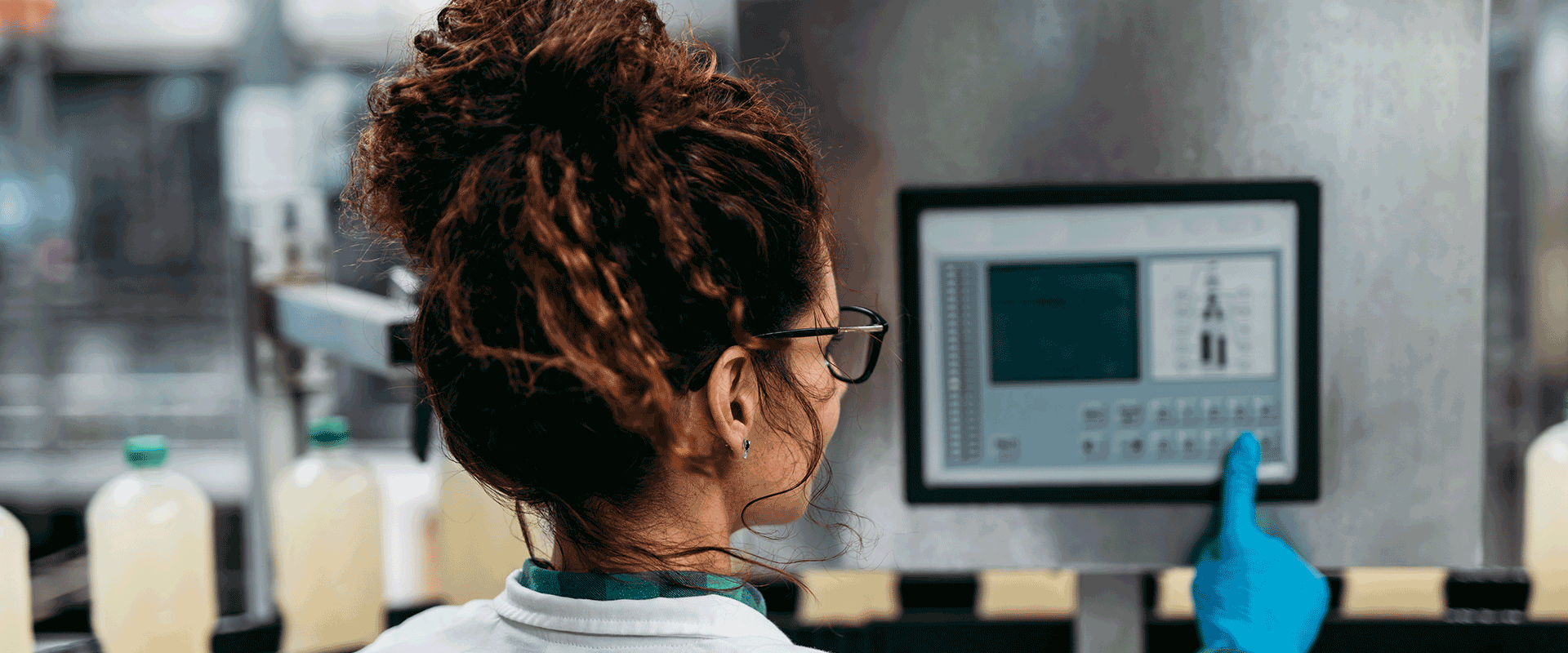 researcher in packaging facility using screen