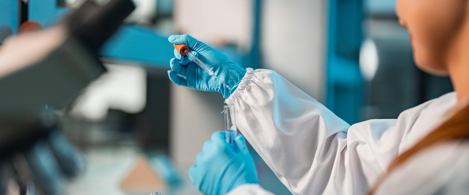 researcher pipetting into vials