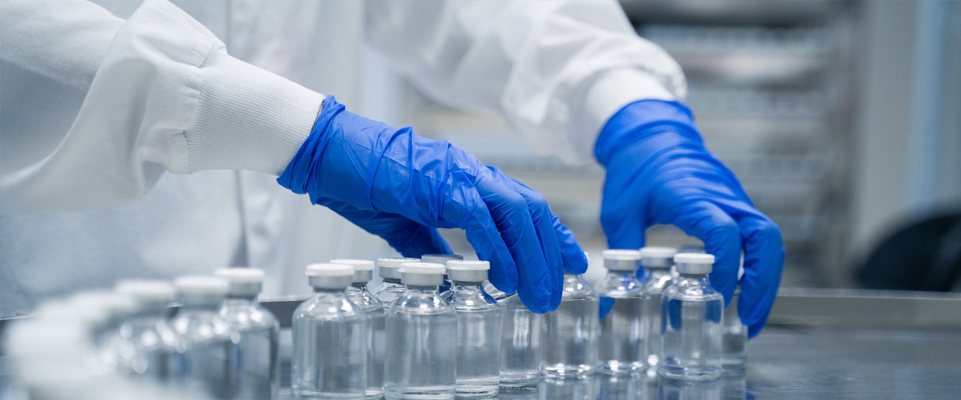Person organizing bottle in medicine packaging plant