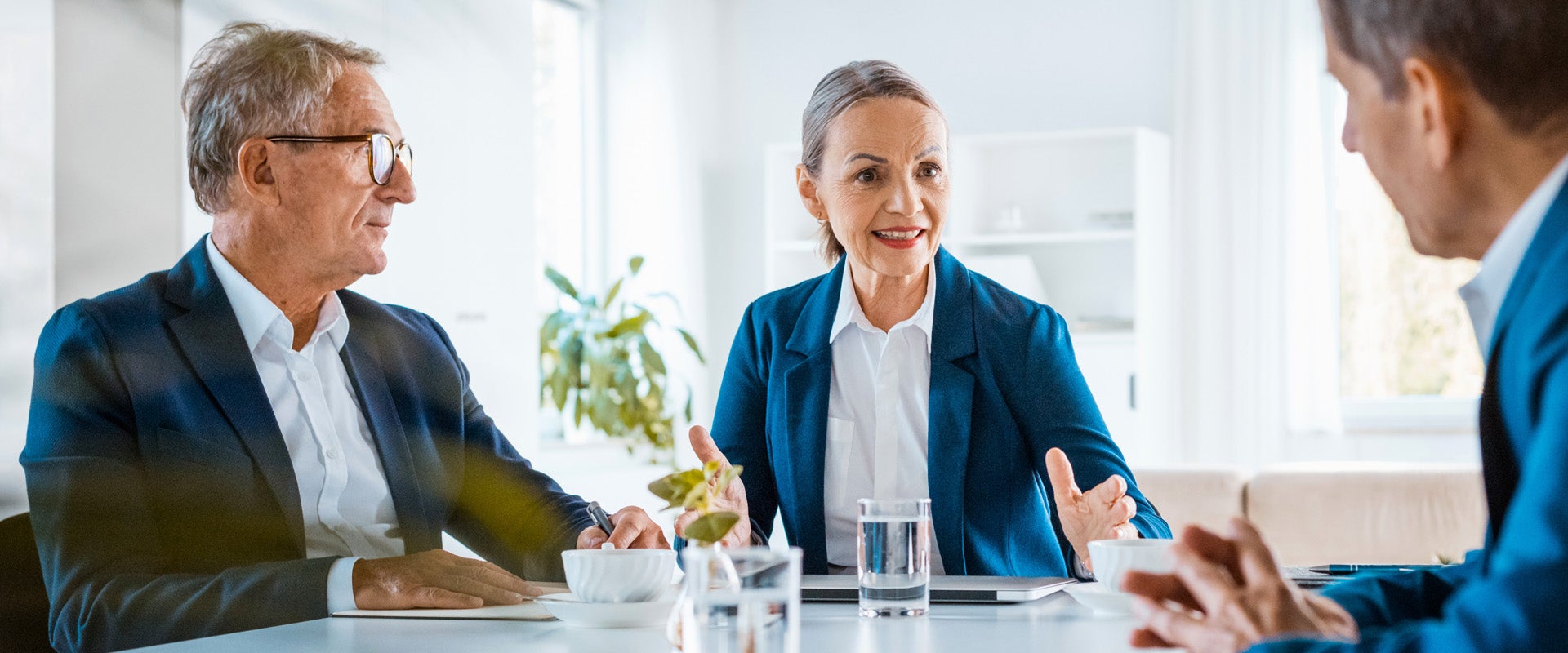 Medical administrators discussing governance in a conference room