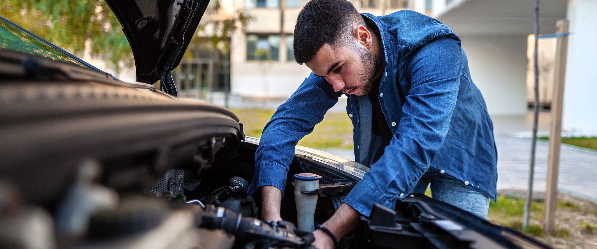 man fixing car