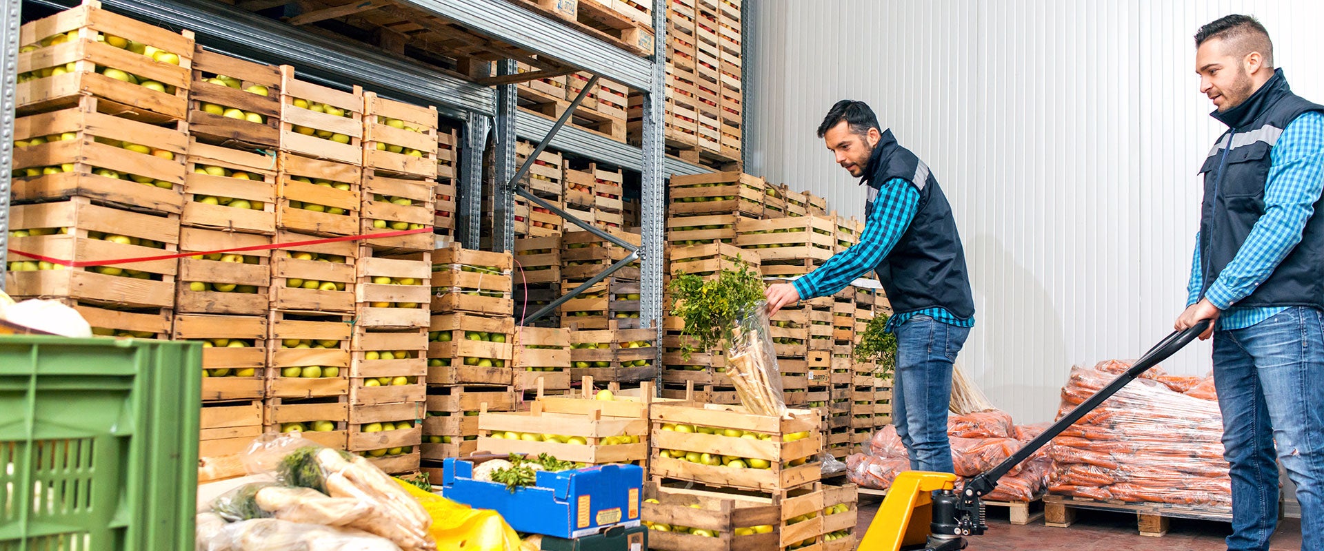 two workers in produce warehouse storage room