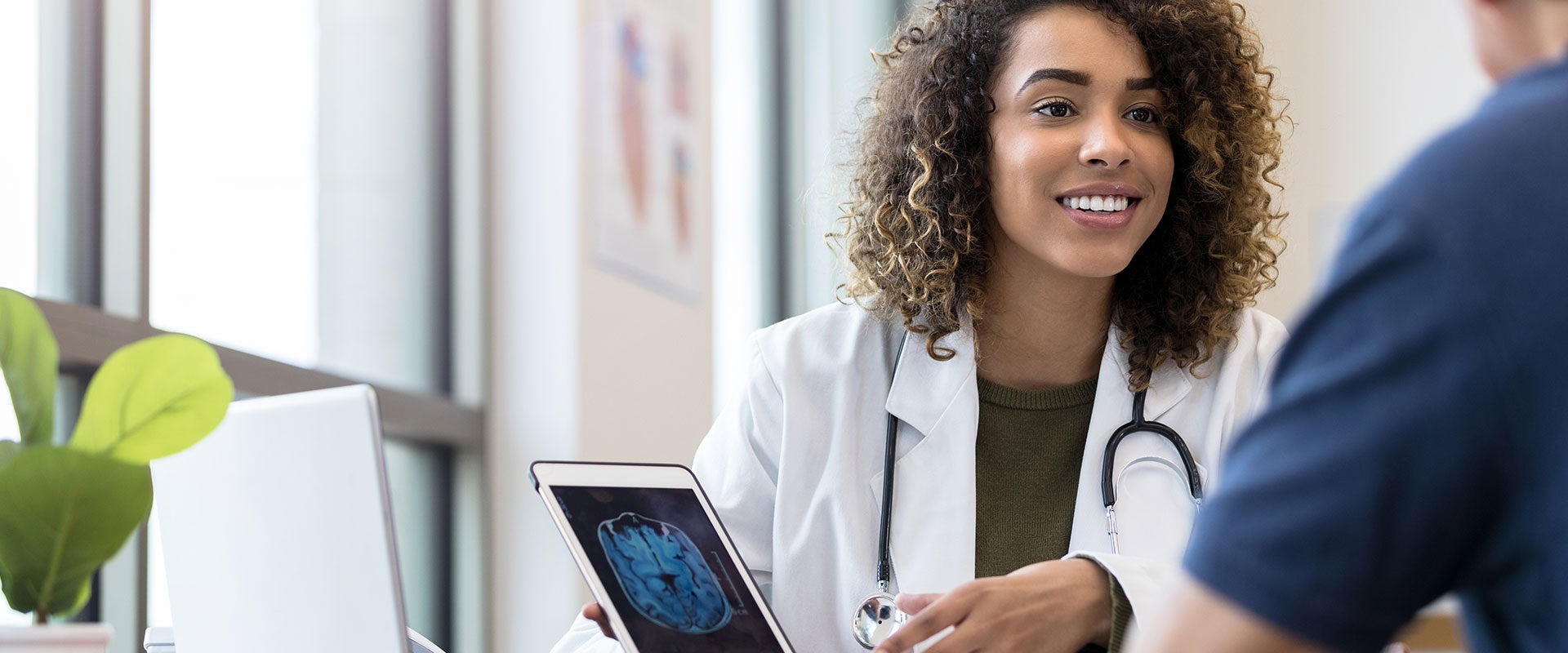 smiling doctor holding tablet