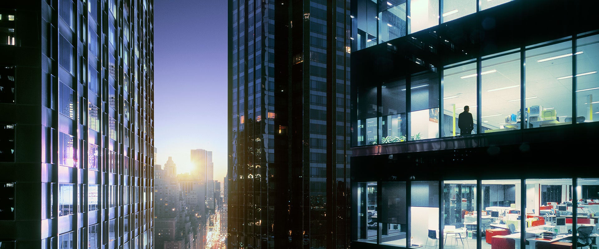 person in window of skyscraper