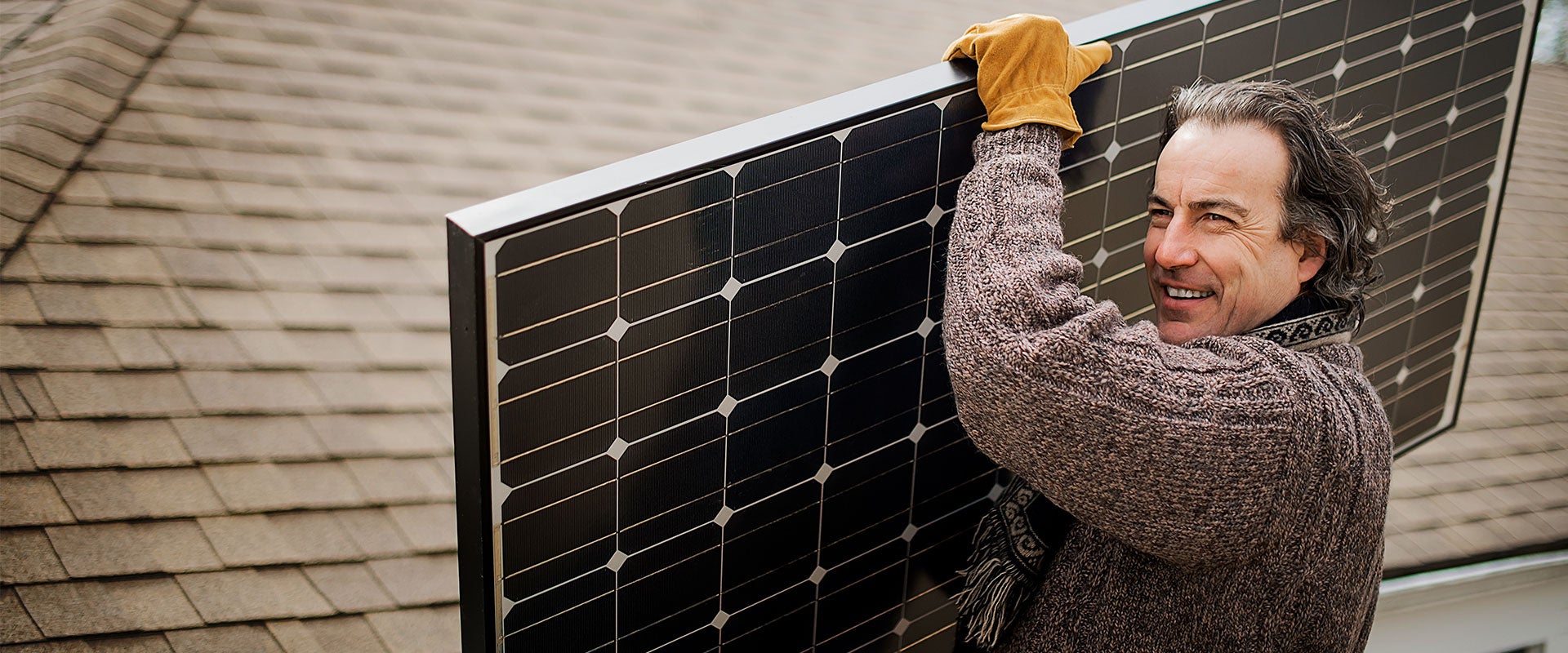 man carrying solar panel