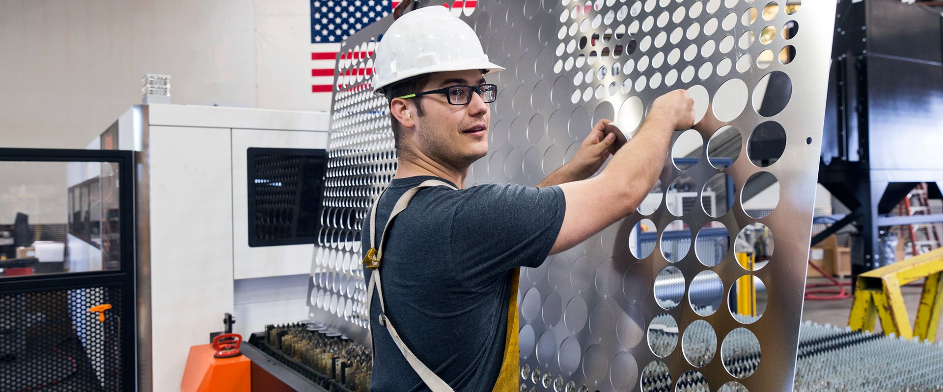 industrial equipment worker with metal sheet