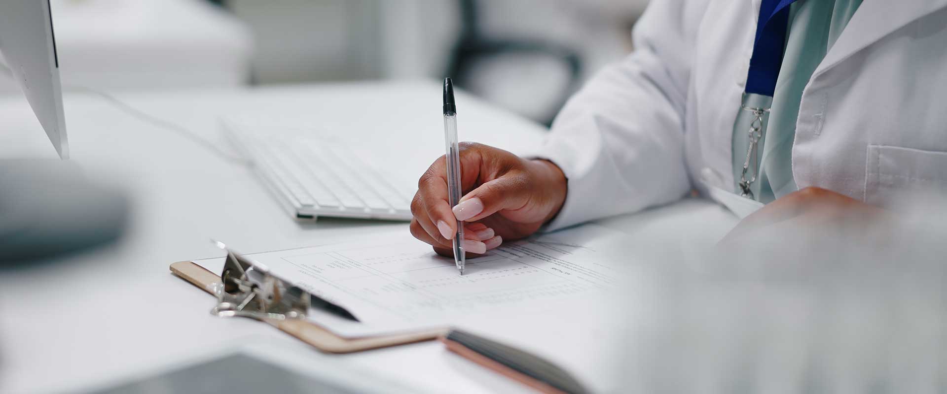 doctor writing on clipboard