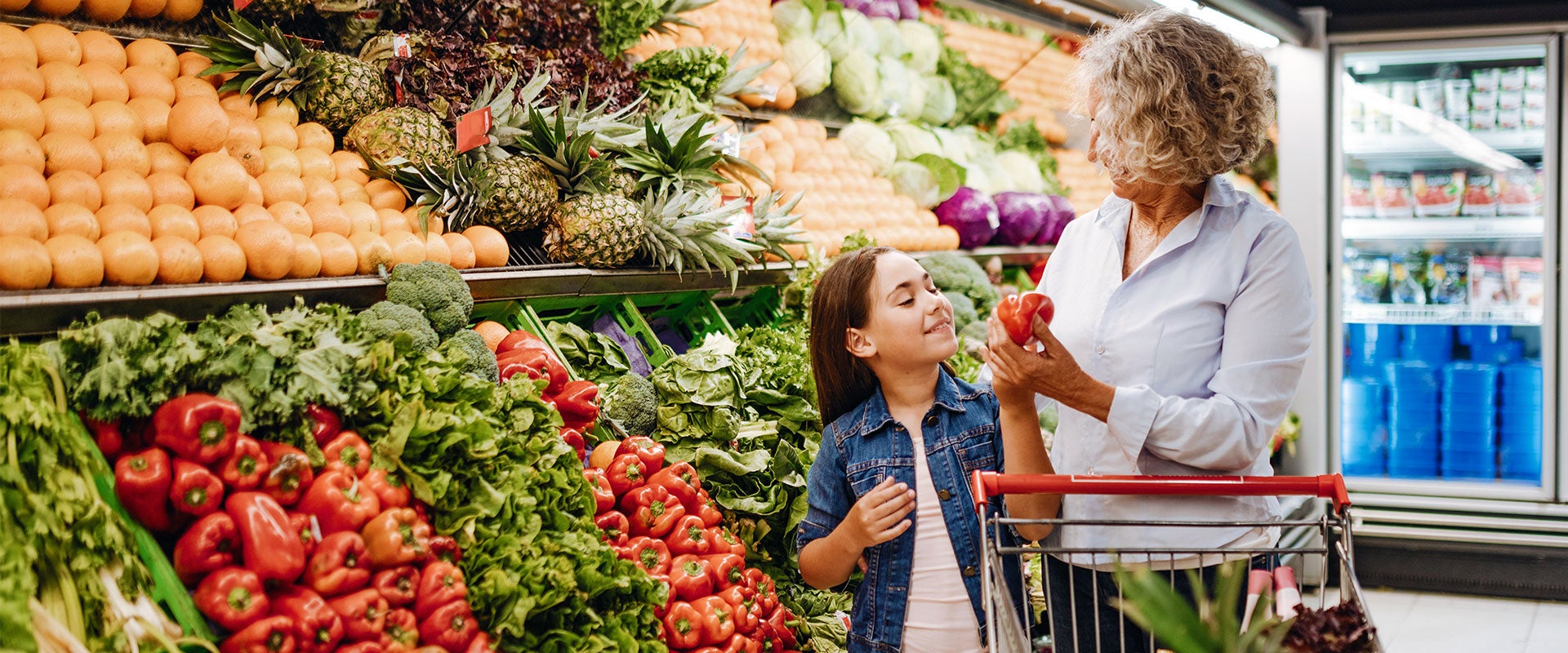 grandmother and granddaughter grocery shopping